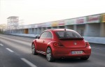 2012-Volkswagen-Beetle-in-red,-rear-exterior-in-motion